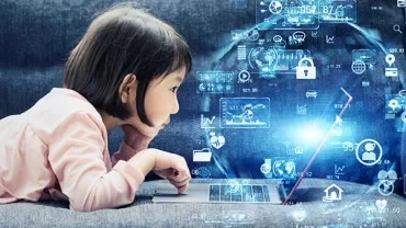 Child using a laptop with digital icons in the foreground.