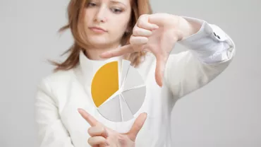 Person in white suit framing a floating pie chart.